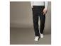 Un homme avec un pantalon cargo noir et des chaussures blanches.