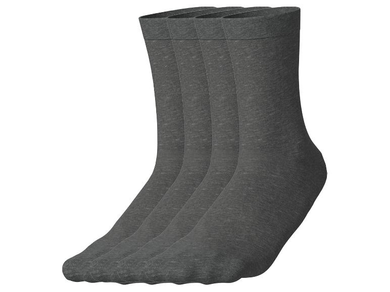 Quatre paires de chaussettes gris foncé, alignées en rang.