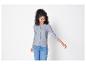 Une femme portant un cardigan gris et un jean bleu.
