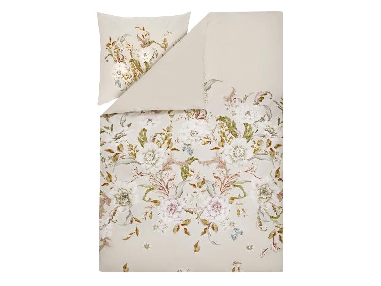 Parure de lit beige avec motif floral blanc et vert.