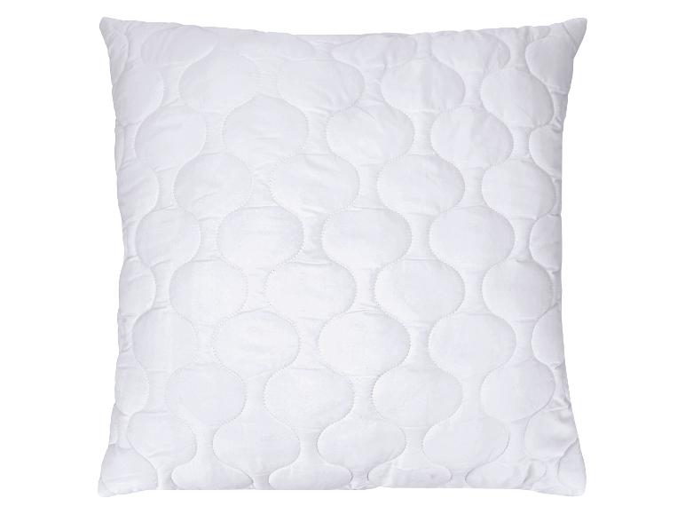 Oreiller blanc matelassé avec un motif circulaire