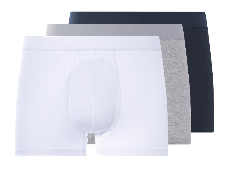 Trois boxers homme : blanc, gris et marine.