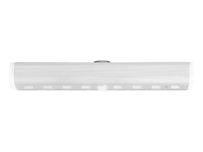 Lampe LED avec détecteur de mouvement, avec boîtier argenté et extrémités blanches.