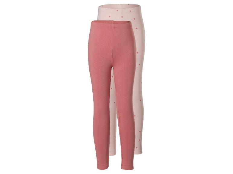 Deux paires de leggings pour enfants, un rose uni et un rose clair à pois.