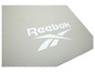 Un tapis de yoga Reebok beige avec une texture rainurée.
