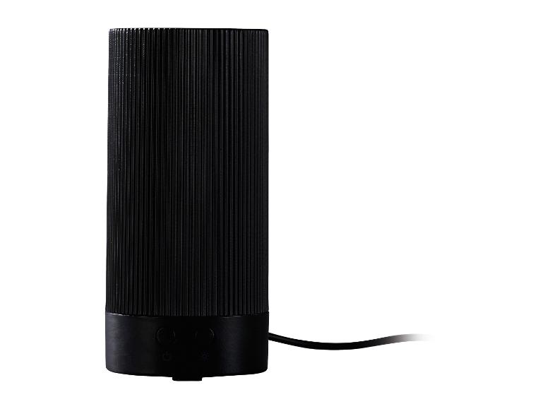 Lampe de table cylindrique noire avec texture côtelée et boutons de commande à la base.