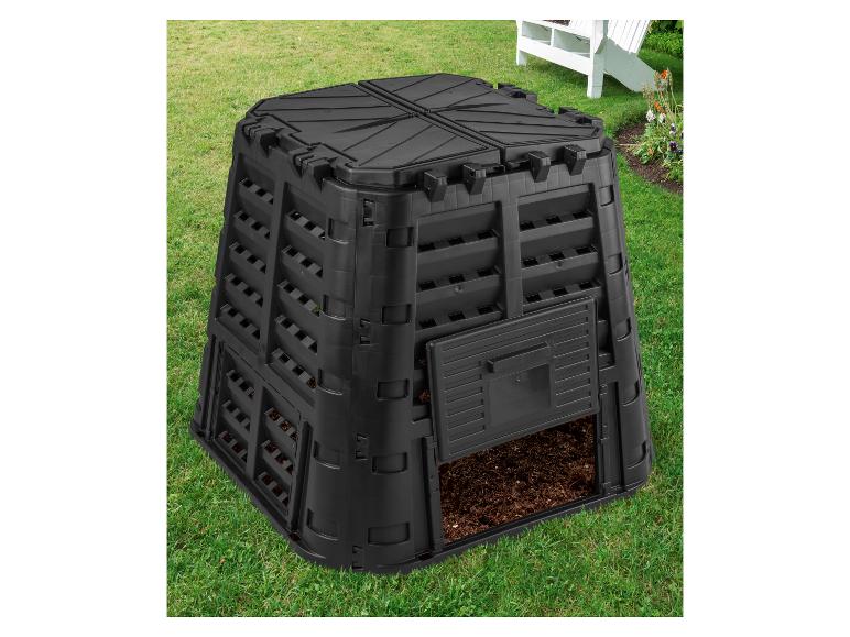 Composteur de jardin noir avec compost, sur herbe verte