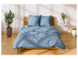 Un lit avec une couette bleue à motifs blancs.