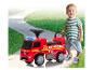 Un jeune enfant avec un camion de pompiers jouet Mercedes-Benz.