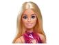 Poupée Barbie aux cheveux blonds, yeux bleus et robe rose brillante.
