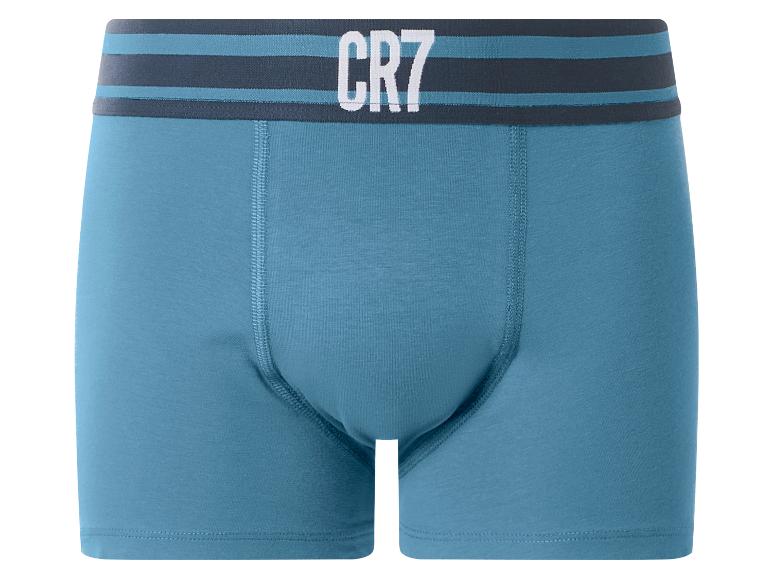 Caleçon bleu pour homme avec ceinture rayée et texte blanc.
