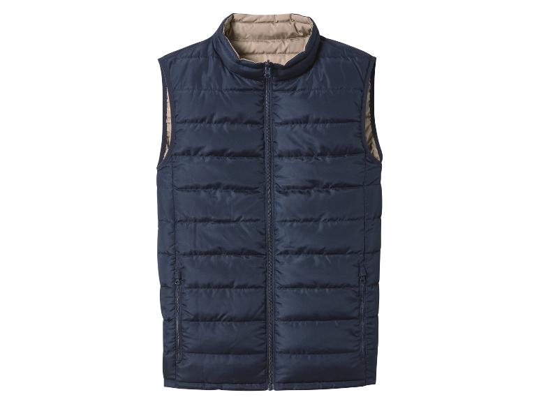 Gilet matelassé bleu foncé avec doublure intérieure beige et fermeture éclair.