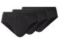 Trois slips noirs en coton pour hommes, empilés en diagonale les uns sur les autres.