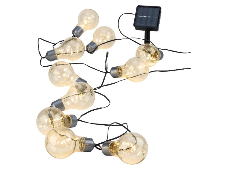 Guirlande solaire avec ampoules LED style rétro, idéale pour le jardin.