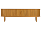 Buffet en bois avec portes à lattes et bords arrondis, sur pieds fins.