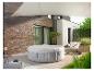 Bain à remous gonflable avec couverture sur une terrasse avec chaise suspendue et voile d'ombrage.