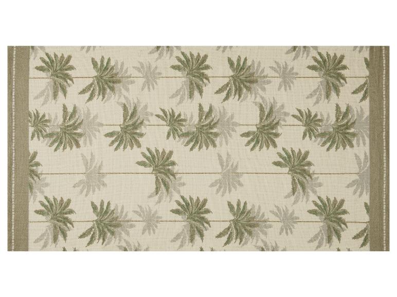 Tapis beige avec motif de feuilles de palmier et bordures marron.