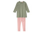 Une robe verte à pois blancs et un legging rose.