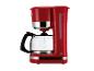 Cafetière rouge avec carafe en verre et indicateur de niveau d'eau visible.