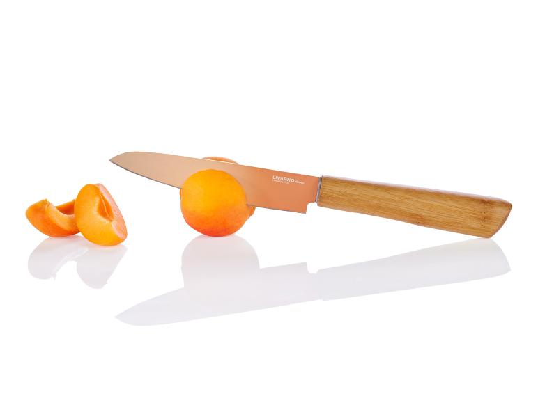 Un couteau Livarno Home avec manche en bois à côté d'une pêche.
