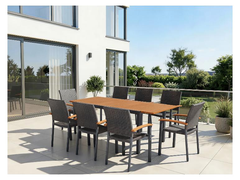 Ensemble de mobilier de jardin avec table en bois et huit chaises sur une terrasse.