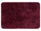 Tapis de bain bordeaux foncé texturé tricoté.
