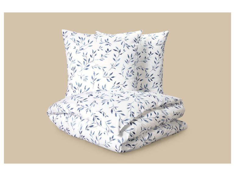 Parure de lit à motif feuilles bleues: deux oreillers et une couette.