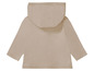 Sweat à capuche beige pour bébé avec manches longues.
