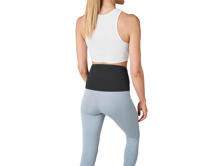 Femme en top blanc, leggings bleu clair et ceinture lombaire noire.