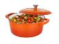 Une cocotte orange avec des légumes mijotés.