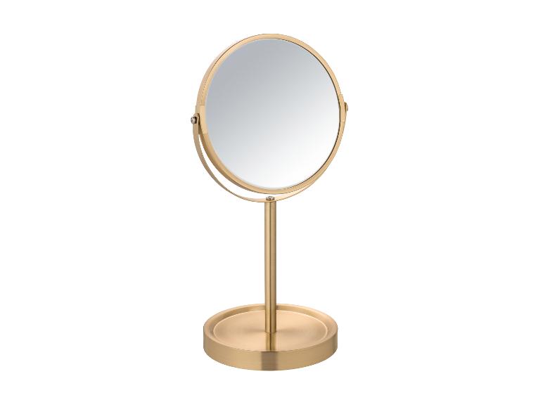 Miroir de table doré avec cadre rond.