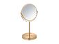 Miroir de table doré avec cadre rond.