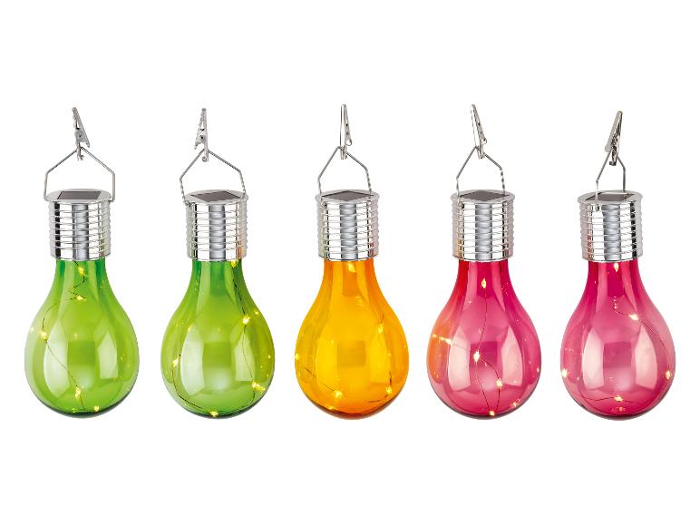 Cinq ampoules LED solaires colorées avec pinces, en vert, orange et rose.