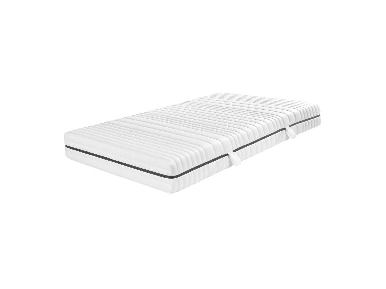 Un matelas blanc avec une bordure grise.