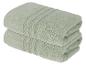 Deux serviettes en coton vert clair pliées