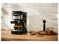 Machine à expresso noire et argentée préparant deux tasses de café dans une cuisine moderne.