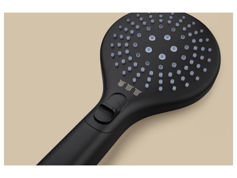 Pommeau de douche noir avec différents modes de jet sur fond beige.