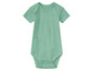 Un body bébé de couleur vert menthe à manches courtes.