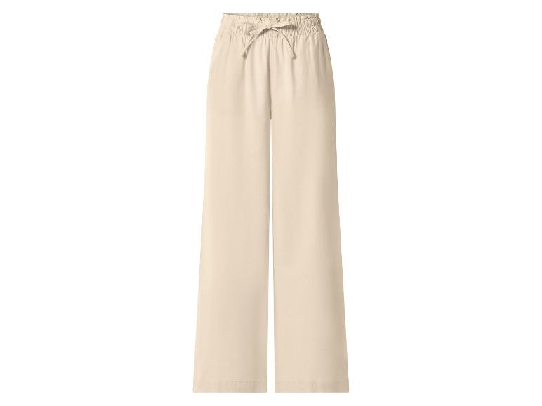 Pantalon large beige avec taille élastique et cordon de serrage.