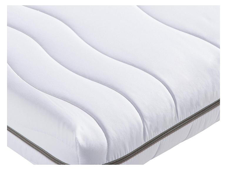 Matelas blanc avec des coutures ondulées et une fermeture éclair grise.