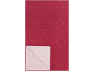 Tissu rouge avec des étoiles dorées et une section blanche pliée.