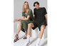 Une femme en robe verte et un homme en t-shirt noir à imprimé léopard.