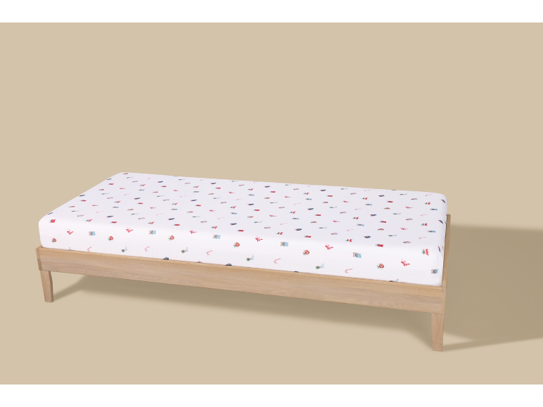 Drap-housse blanc à motifs festifs sur un cadre de lit en bois
