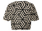 Top beige avec un motif géométrique noir.