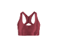 Soutien-gorge de sport bordeaux avec bretelles croisées sur fond noir.