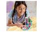 Une fille joue avec un jouet Gabby's Dollhouse sur une couverture douce.