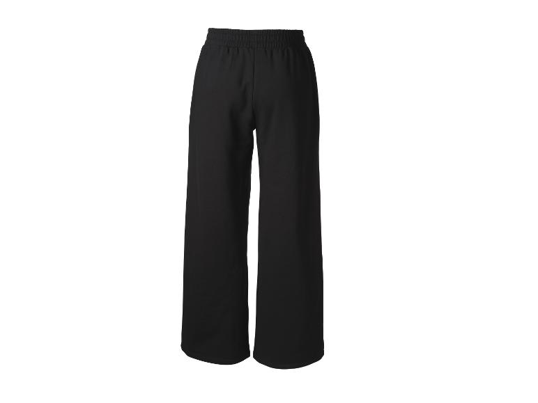 Pantalon noir ample à taille élastique, sur fond blanc.