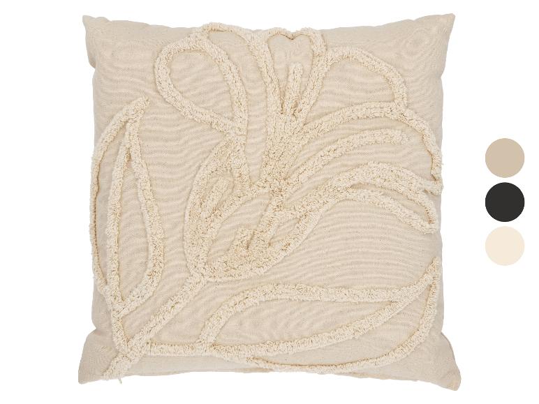 Coussin beige avec motif de feuilles touffues et palette de couleurs.