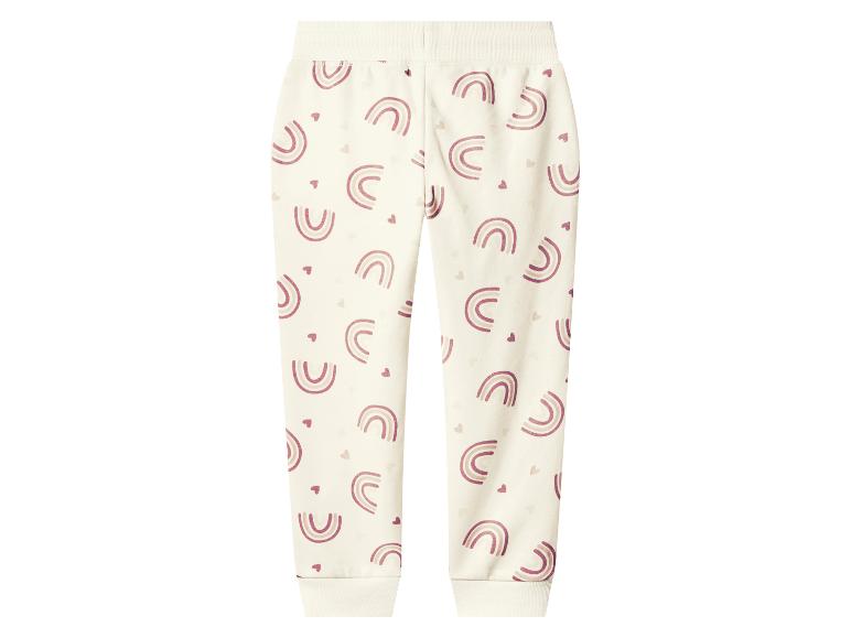 Pantalon de survêtement enfant couleur crème avec motifs arcs-en-ciel et cœurs roses.