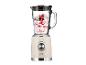 Un blender beige style années 1970 avec un bol en verre rempli d'un smoothie aux baies.